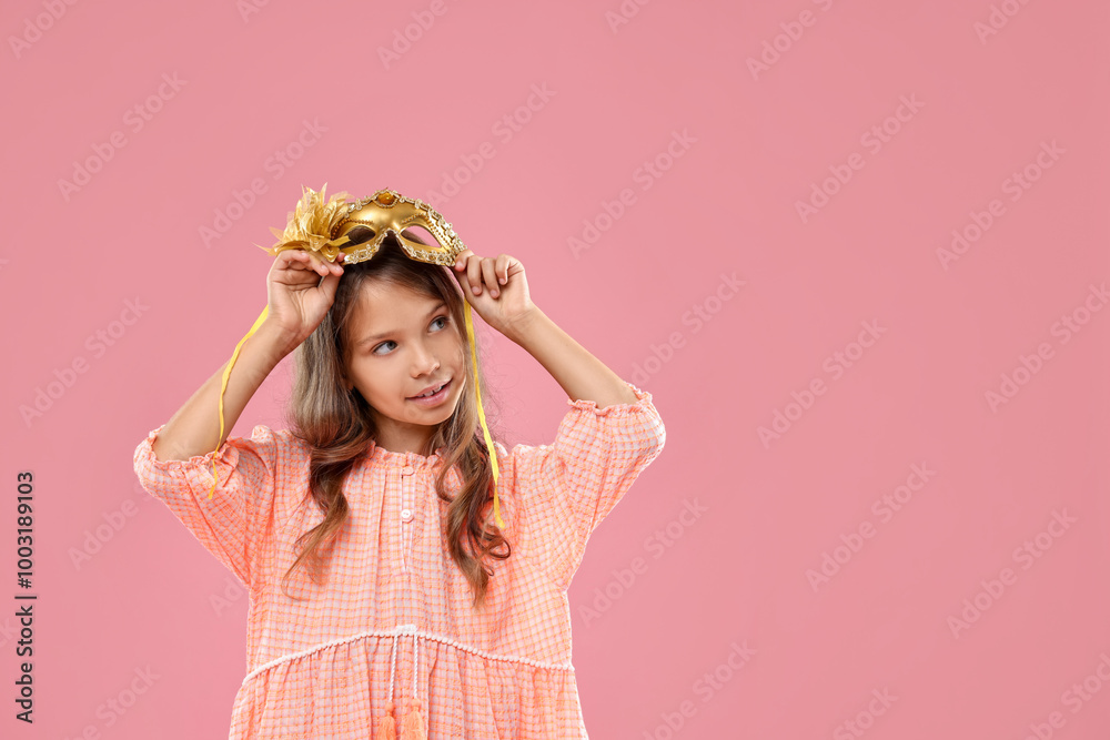 Cute girl wearing carnival mask on pink background, space for text