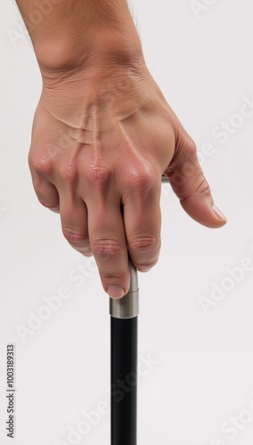 Close-up portrait of an older gentleman with wrinkled skin and graying hair gripping his worn cane amidst the growing challenge posed by our aging population photo