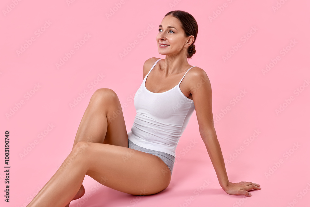 Smiling woman with perfect skin posing on pink background. Body care Smiling woman with perfect skin posing on pink background. Body care