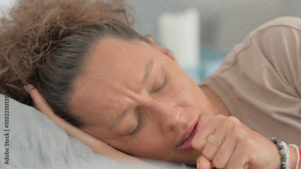 Close up of Hispanic Woman Coughing while Lying on Side in Bed Close up of Hispanic Woman Coughing while Lying on Side in Bed