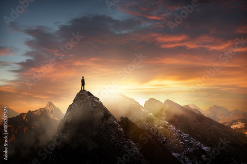 Obraz na płótnie A man standing on top of a mountain at sunset. Goals, challenges and life achievements concept photo composite. w salonie