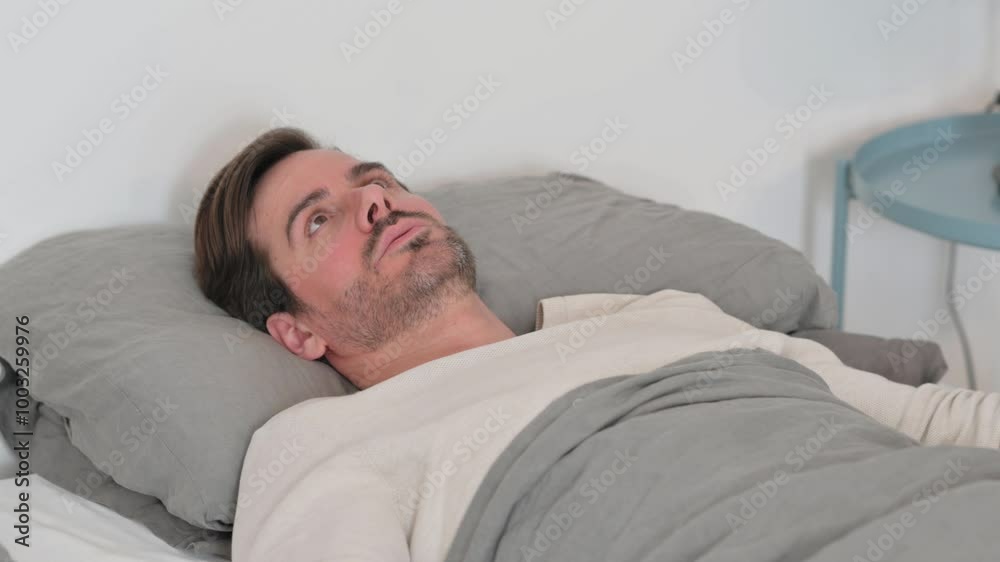 Uncomfortable Young Man Having Nightmare While Sleeping In Bed Stock