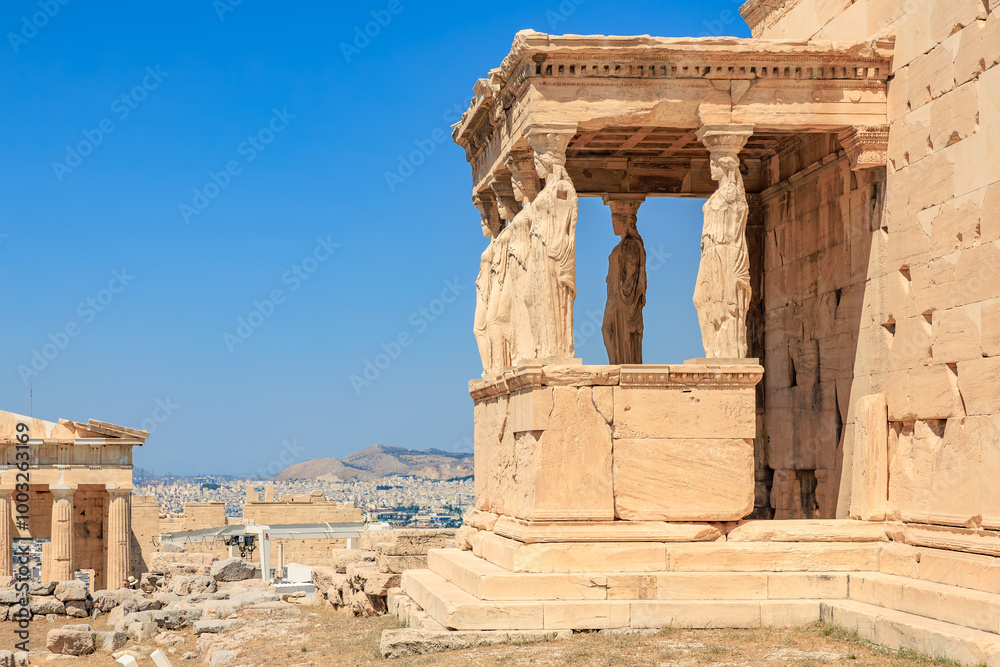 Obraz premium A stone building with a balcony and statues of people on it, Acropolis in Athens
