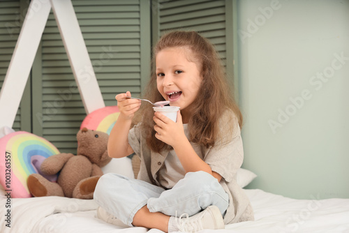 Cute little girl sitting on...