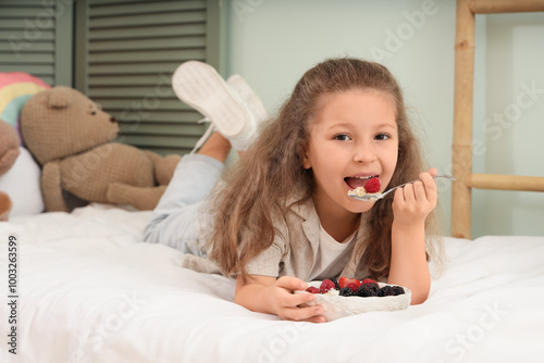 Cute little girl lying on b...