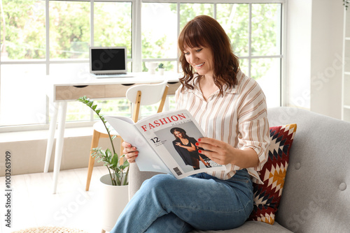 Beautiful woman reading mag...