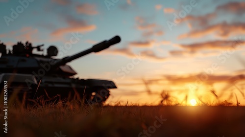 A silhouetted military tank on a field captures the setting sun, conveying power, solitude, and the profound juxtaposition of war machines against serene skies. photo