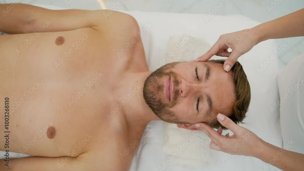 Female Masseuse Giving Relaxing Anti-Stress Head Massage to Male