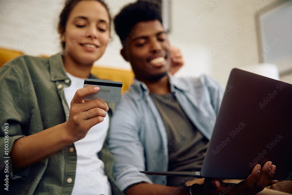 Close up of couple shopping online at home. Close up of couple shopping online at home.