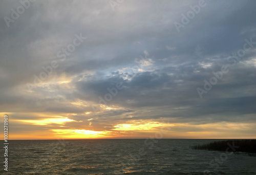 Autumn sunrise over the Curonian Lagoon. View of the bay from the resort town of Nida, Lithuania. photo