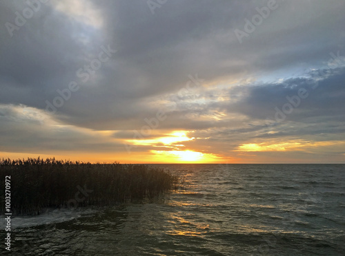 Autumn sunrise over the Curonian Lagoon. View of the bay from the resort town of Nida, Lithuania. photo