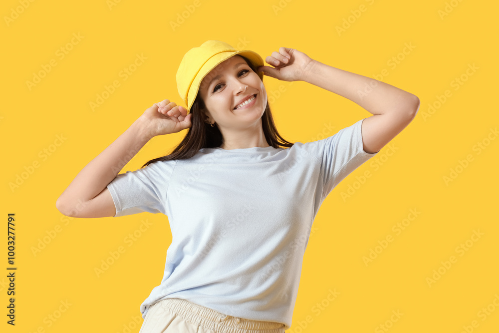Young woman in bucket hat on yellow background Young woman in bucket hat on yellow background
