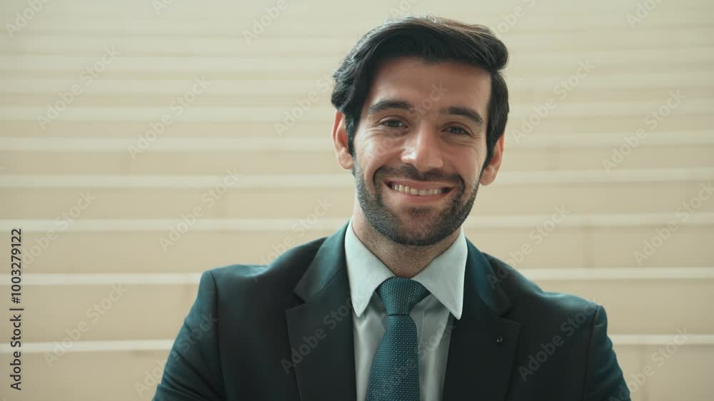 Caucasian smiling business man looking at camera while standing at stairs. Closeup of successful man smiling at camera while wearing business suit. Happy executive manager look at camera. Exultant. Caucasian smiling business man looking at camera while standing at stairs. Closeup of successful man smiling at camera while wearing business suit. Happy executive manager look at camera. Exultant.
