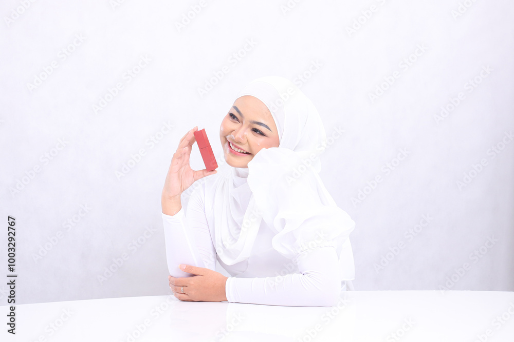 Beautiful cheerful young veil woman asia lip makeup view top right hand holding lipstick container and sticking elbow isolated white background. beauty education, lip care, lipstick mock up container Beautiful cheerful young veil woman asia lip makeup view top right hand holding lipstick container and sticking elbow isolated white background. beauty education, lip care, lipstick mock up container