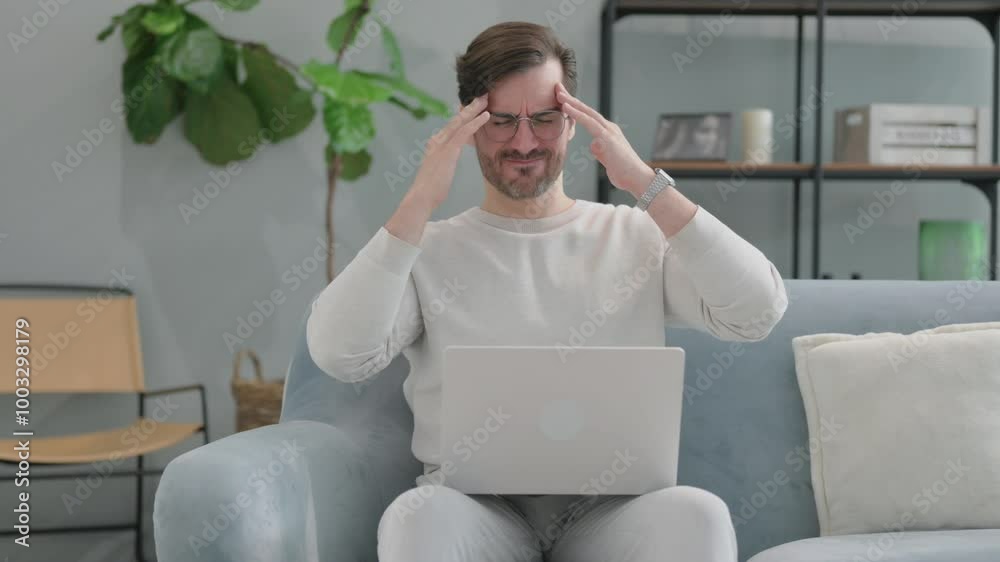 Young Man having Headache while Using Laptop at Home Young Man having Headache while Using Laptop at Home