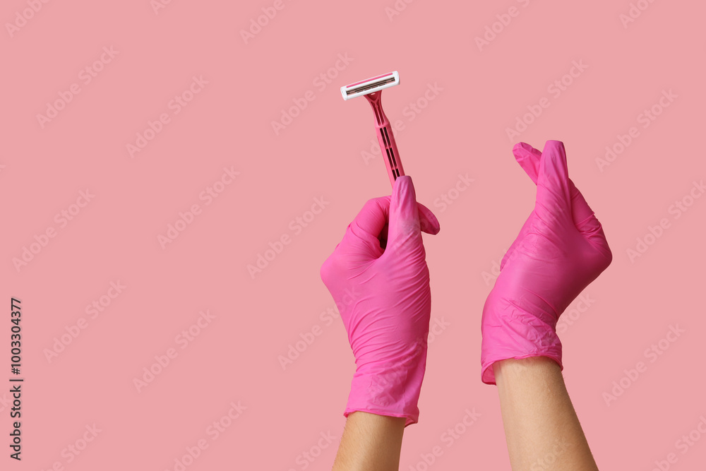 Female hands with razor showing heart gesture on pink background ...