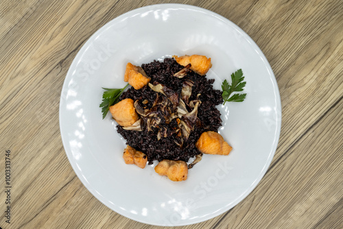 Overhead view of bite sized salmon served over a bed of black rice and cooked to perfection photo