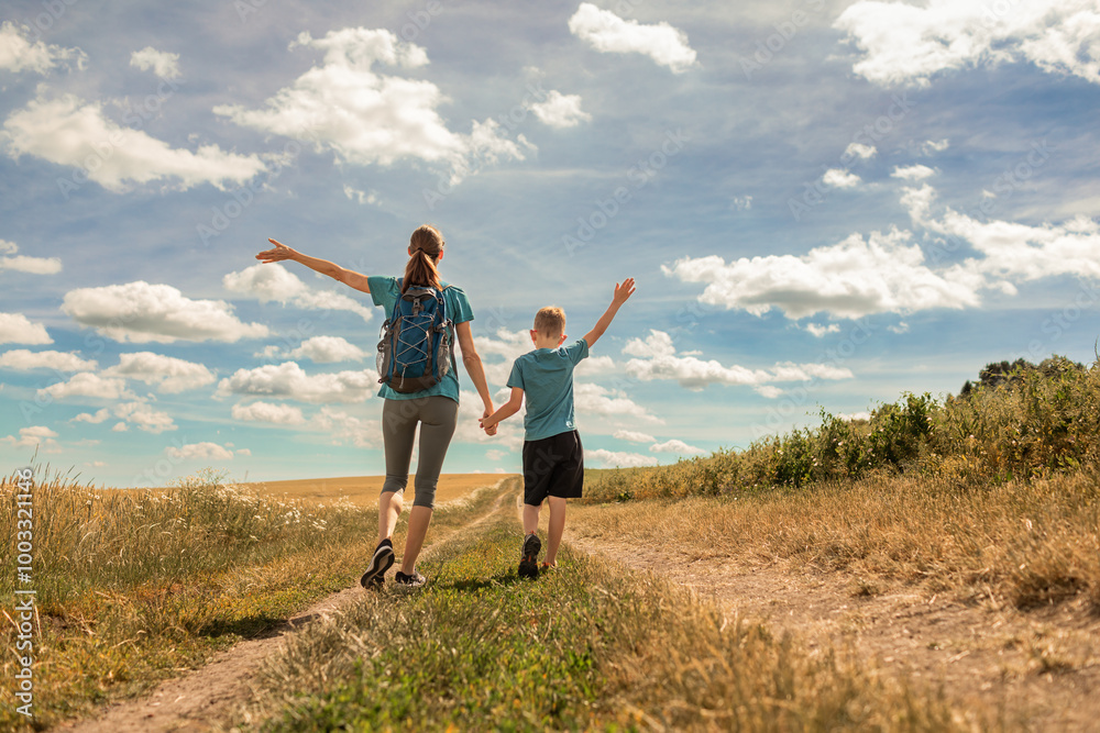 Happy mother and child walking together in the countryside Happy mother and child walking together in the countryside