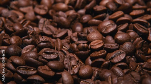Close-up view of rotating roasted coffee beans in 4K quality.