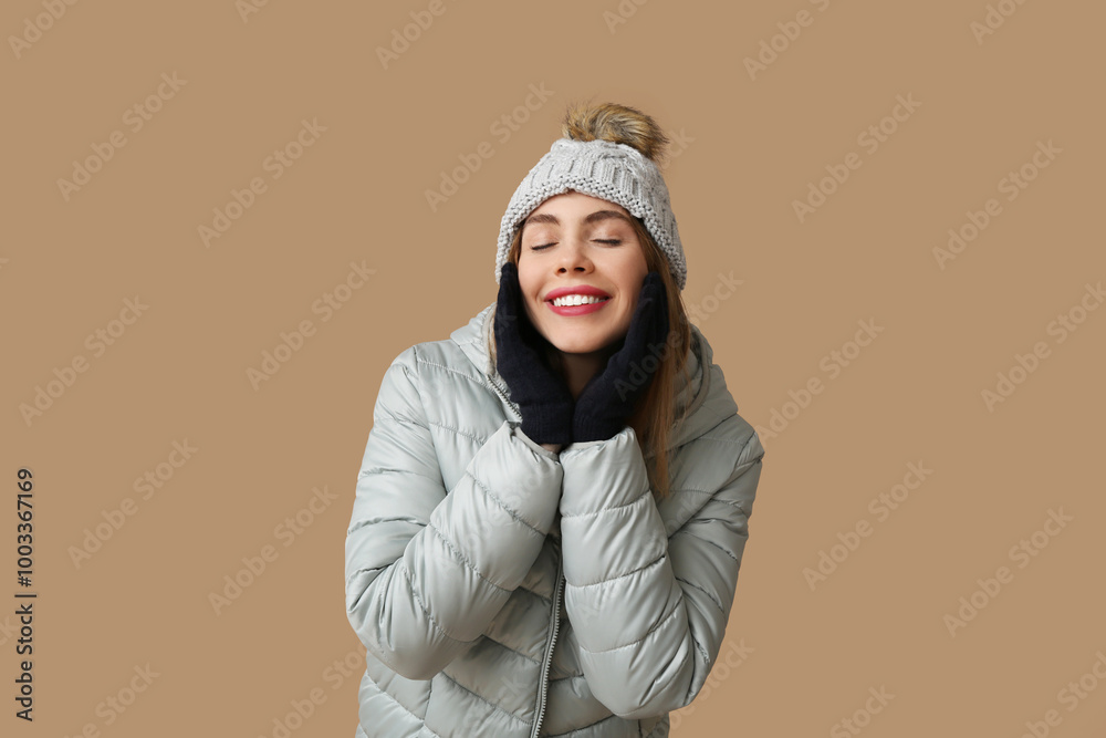 Beautiful young happy woman in warm winter clothes on brown background Beautiful young happy woman in warm winter clothes on brown background