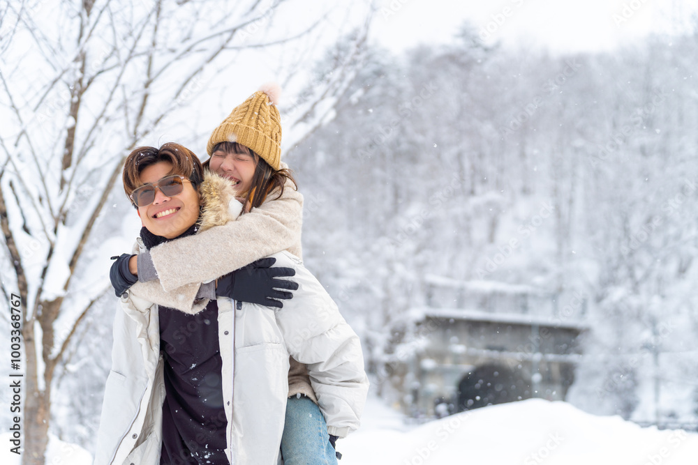 Fototapeta premium Happy young Asian man and woman couple enjoy and fun outdoor lifestyle playing snow together during road trip travel countryside and forest mountain in Japan on winter snow holiday vacation.