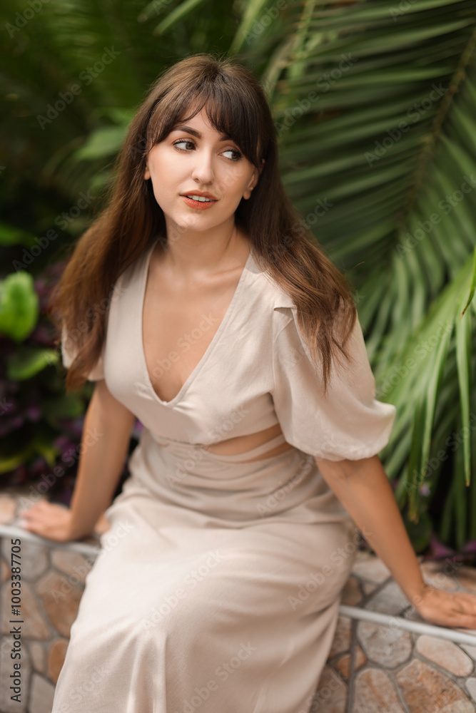 Beautiful woman posing near palm plants outdoors Beautiful woman posing near palm plants outdoors