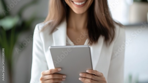 Smiling Woman Holding Tablet in Modern Workspace