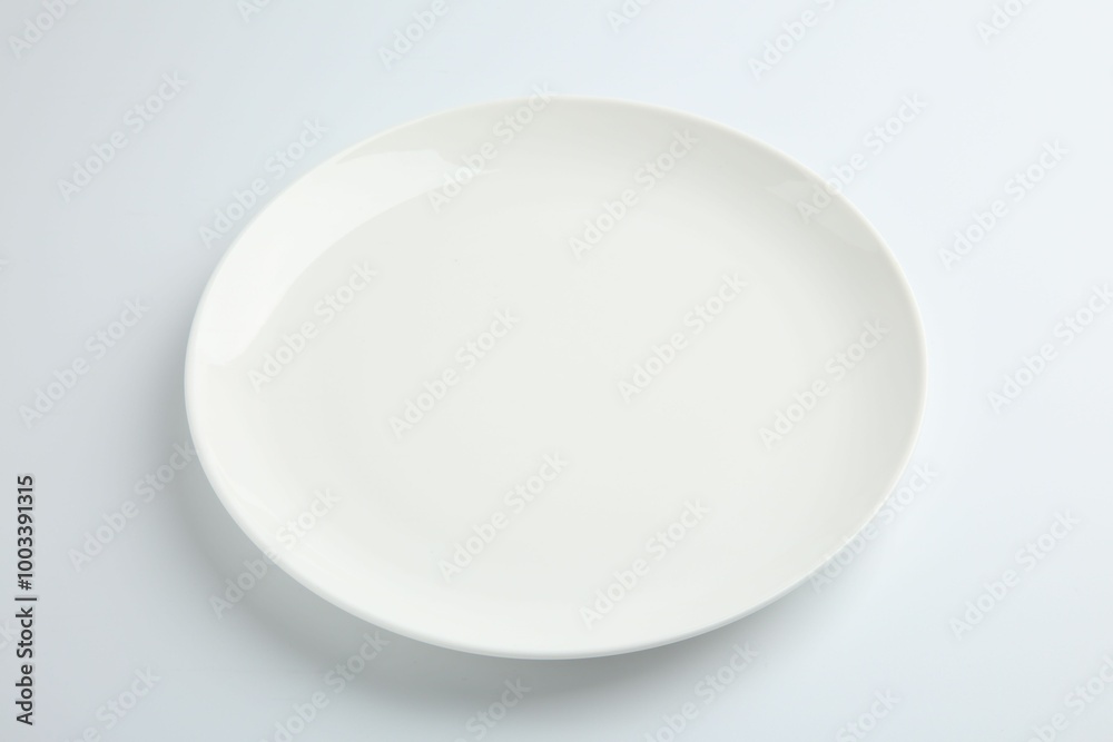 One empty ceramic plate isolated on white One empty ceramic plate isolated on white