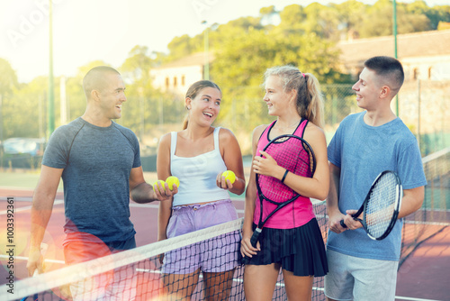 Team of men and women after playing tennis on the tennis court photo