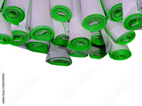 group of digital printed banner rolls with copy space for text. stack of packaged products. white tarpaulin printed with green
