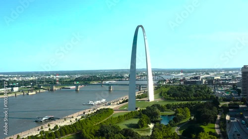 A breathtaking view of the St. Louis Arch overlooking the river, capturing the iconic structure's grandeur and its reflection in the water, symbolizing the Gateway to the West.