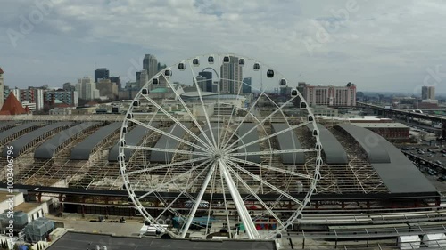 A stunning view of the St. Louis Wheel, a towering Ferris wheel offering panoramic views of the city skyline, capturing the vibrant atmosphere of the Gateway Arch area.