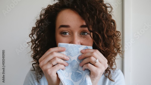 Woman Hiding Face with a Blue and White Patterned Napkin.