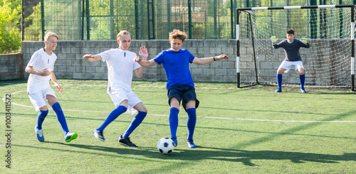 Teens playing soccer football match. Competition between two youth soccer teams. Football soccer tournament photo