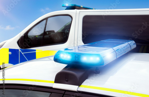 Фотография Police car lights - flashing emergency services siren from police vehicle lightbar