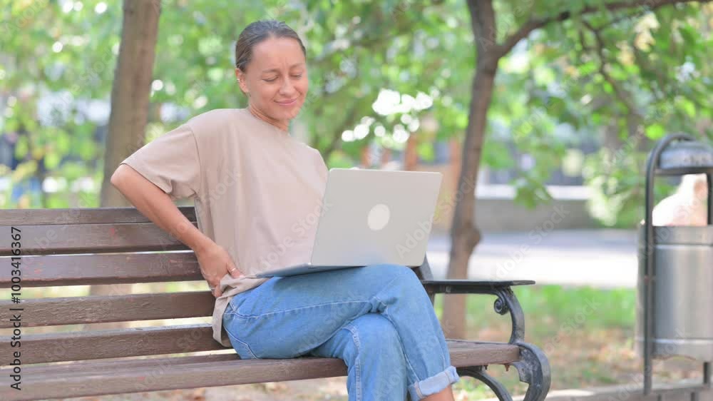 Tired Young Hispanic Woman with Back Pain Using Laptop Outdoor Tired Young Hispanic Woman with Back Pain Using Laptop Outdoor