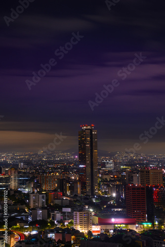 Mexico City Night Skyline at Moon Rise in Ciudad de México: Beautiful vibrant historic metropolis and one of the most populous cities in North America at an altitude of 7,350 ft. #1003419702