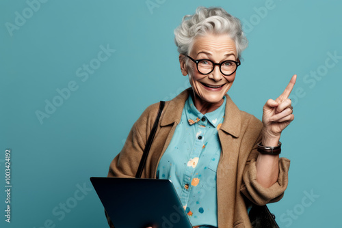 Happy Senior Woman Pointing Up with Laptop