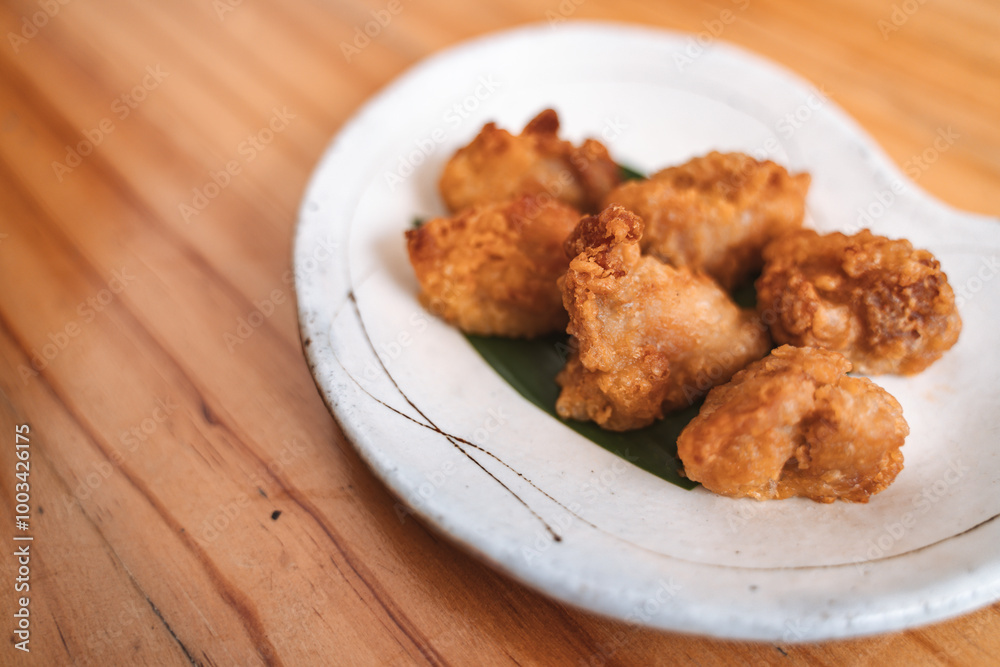 Crispy fried chicken pieces served on a decorative plate. Crispy fried chicken pieces served on a decorative plate.