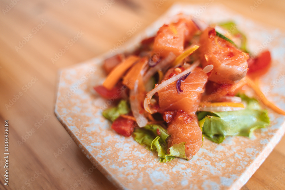 Spicy salmon salad with vegetables on a decorative plate. Spicy salmon salad with vegetables on a decorative plate.