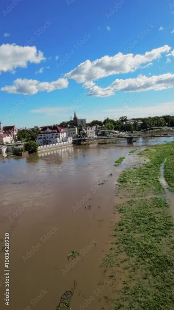 This video showcases the serene beauty of a river flowing through the heart of a bustling city. The rivers calm waters are a stark contrast to the busy streets and tall buildings that line its banks This video showcases the serene beauty of a river flowing through the heart of a bustling city. The rivers calm waters are a stark contrast to the busy streets and tall buildings that line its banks