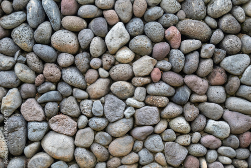 Round pebbles natural stone wall texture for background