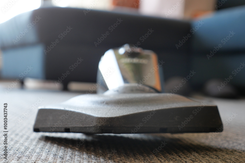 A Detailed CloseUp Shot of a Vacuum Cleaner Head Positioned on a Carpeted Surface A Detailed CloseUp Shot of a Vacuum Cleaner Head Positioned on a Carpeted Surface