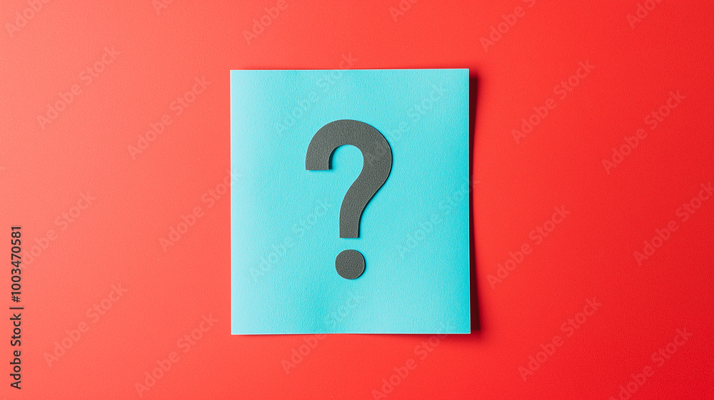Big black question mark lying on blue sticky note on red background Big black question mark lying on blue sticky note on red background