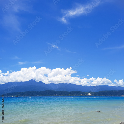 natural view with a composition of sea, mountains, sky and clouds