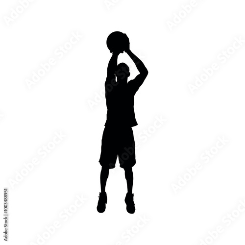 Silhouette of a basketball player making a shot into the hoop