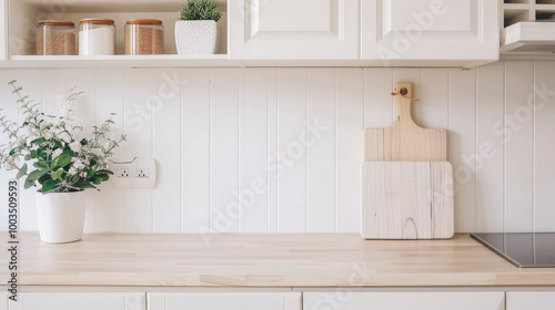 Modern White Kitchen Interior with Wooden Cutting Boards and Fresh Flowers