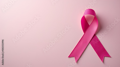 Pink ribbon on textured background symbolizing breast cancer awareness copy space for text