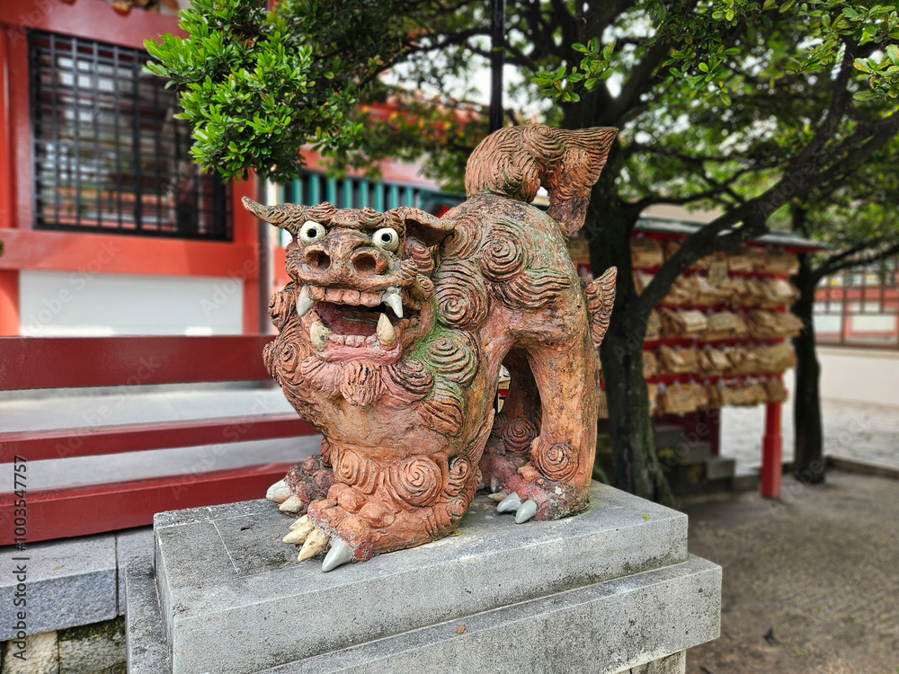 Close up of traditional Shisa lion dog sculpture of Okinawa island decoration on the fence of the house of temple in Okinawa,