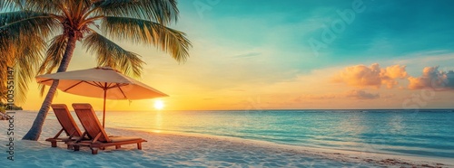 Two beach chairs under an umbrella on a tropical beach at sunset. photo